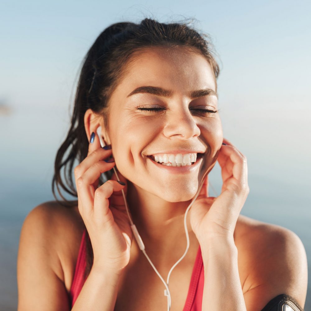 cheerful-sports-woman-listening-music-in-earphones-FJH6PY8.jpg cheerful-sports-woman-listening-music-in-earphones-FJH6PY8.jpg