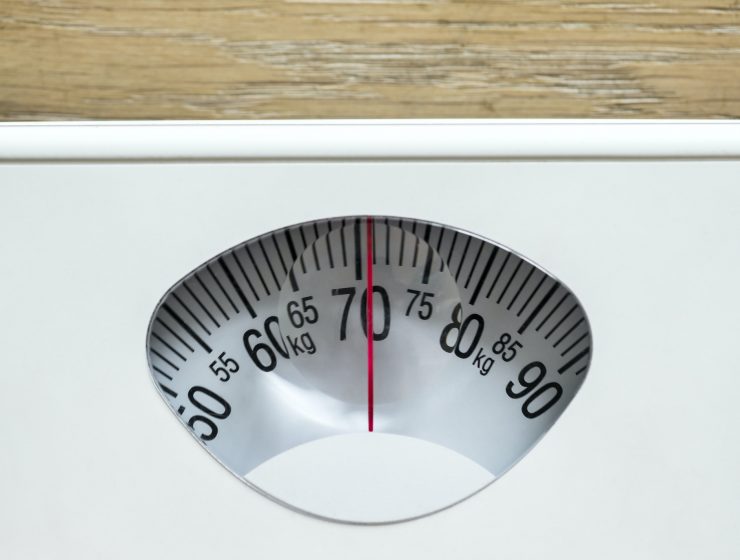 Closeup of weight scales overweight and obesity concept